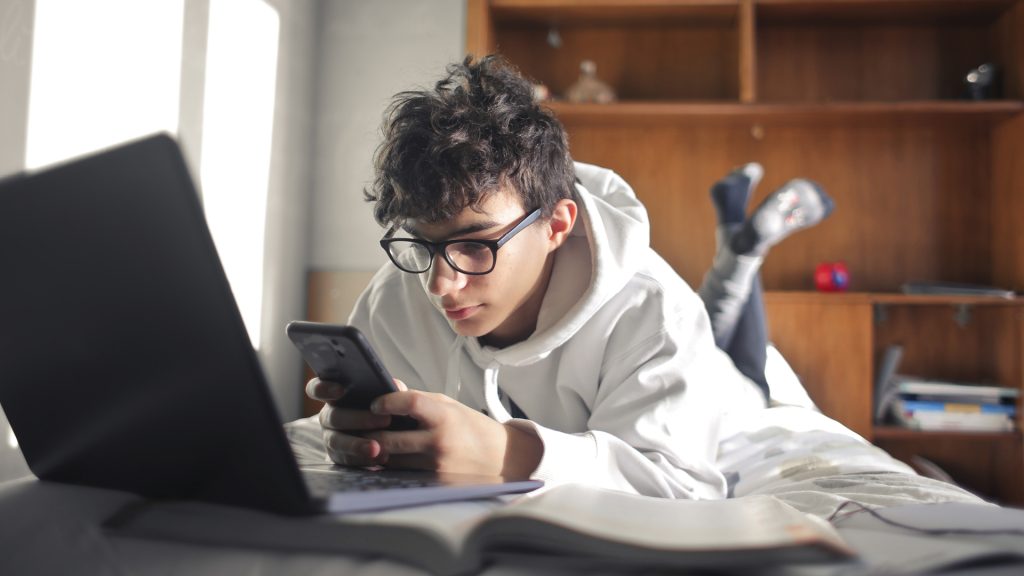 boy on bed on phone