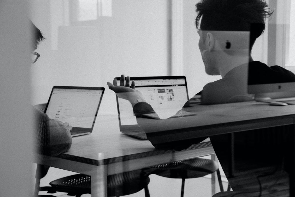 people sitting at desk on laptop
