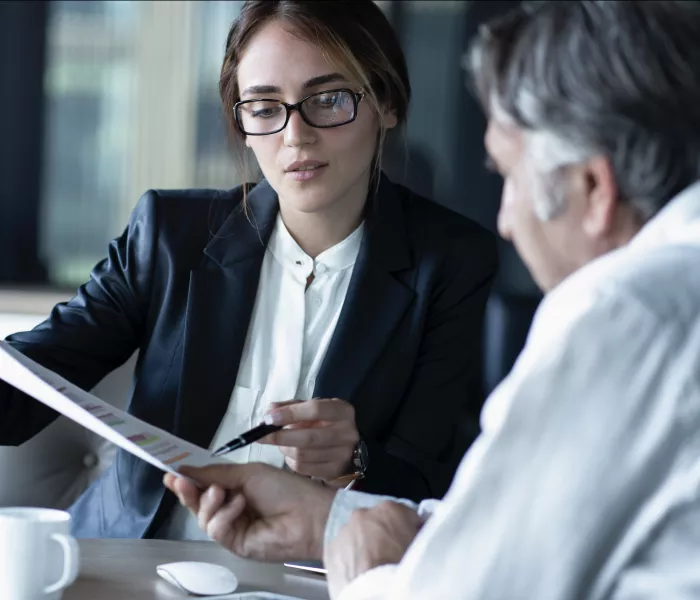 woman showing man paper