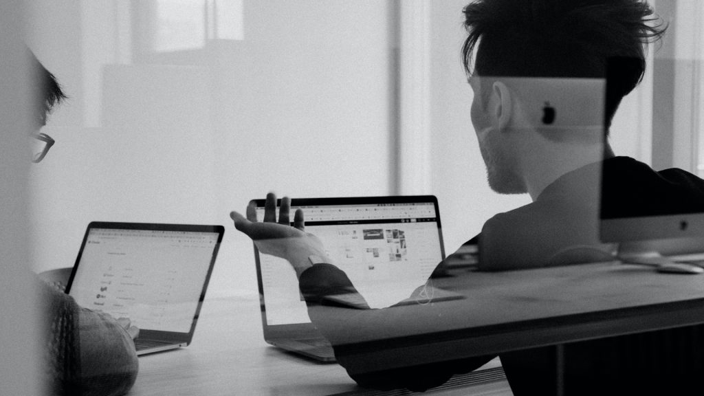 2 people using laptops