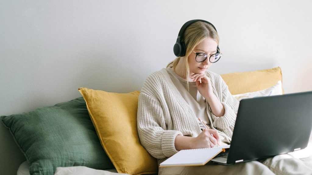 woman sitting on sofa on laptop