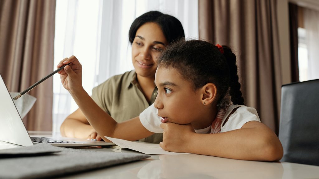 little girl and mom using laptop
