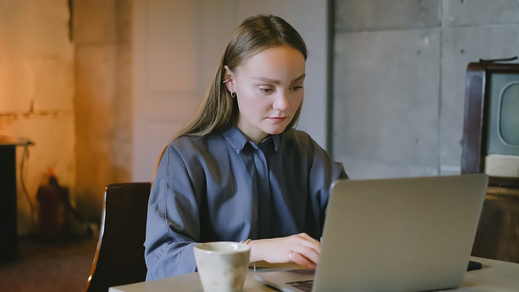 young woman using laptop at desk