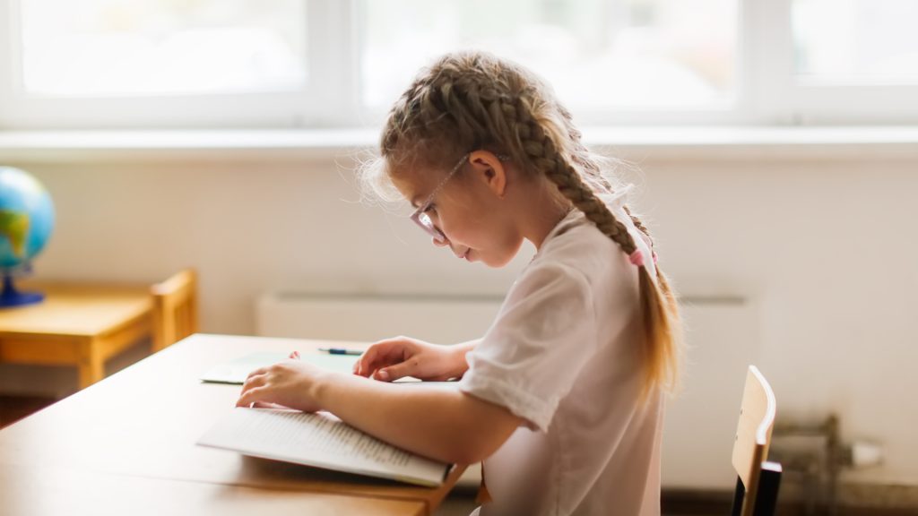 little girl reading a book