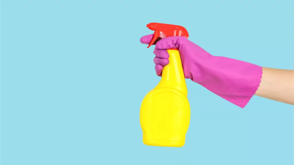 hand with cleaning spray in hand